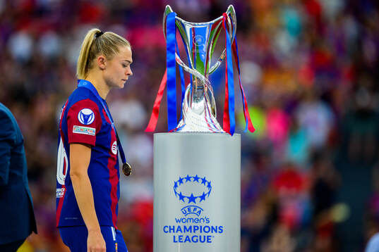 Fridolina Rolfö of Barcelona walks behind the trophy