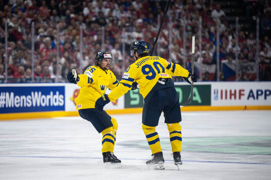 Erik Karlsson and Marcus Johansson of Sweden celebrate the