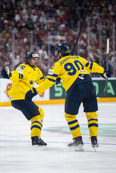 Erik Karlsson and Marcus Johansson of Sweden celebrate the