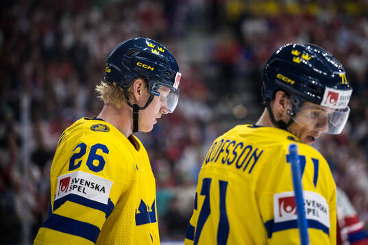 Rasmus Dahlin and Victor Olofsson of Sweden look dejected