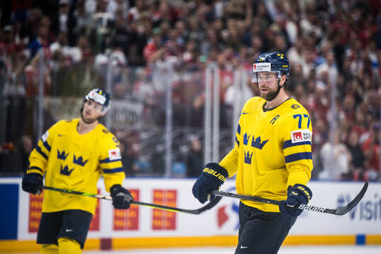 Adrian Kempe and Victor Hedman of Sweden look dejected