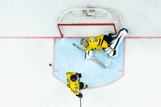 Goaltender Samuel Ersson and Tim Heed of Sweden look