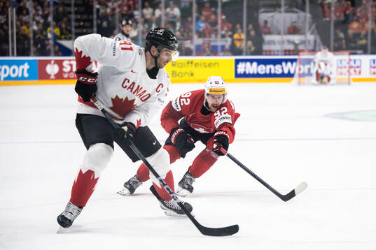 John Tavares of Canada and Gaetan Haas of Switzerland