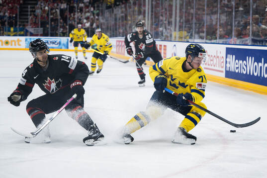 Dylan Guenther of Canada and Victor Olofsson of Sweden