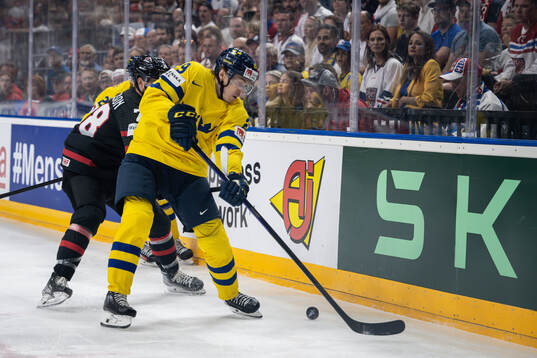 Damon Severson of Canada and Pontus Holmberg of Sweden