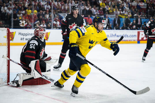 Goaltender Jordan Bennington of Canada and Carl Grundström