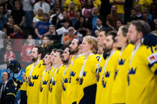 Victor Hedman and Erik Karlsson of Sweden with team mates