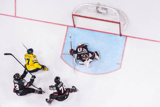 Isac Lundeström of Sweden against goaltender Jordan