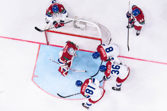 Players of Czech Republic gather around goaltender Lukas