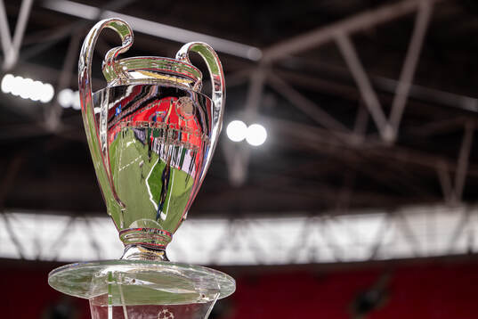 The Champions League trophy is displayed inside the stadium