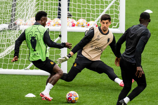 Vinicius Junior and goalkeeper Thibaut Courtois of Real