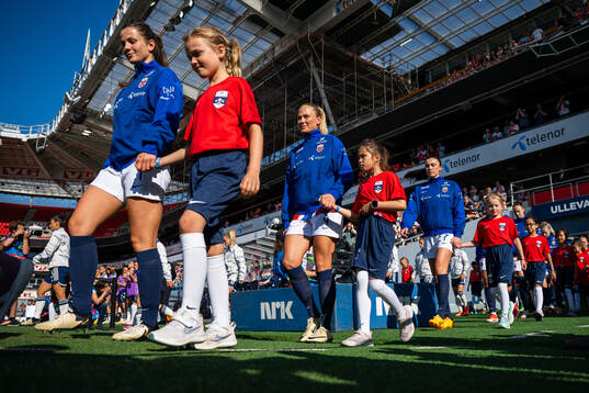 Tuva Hansen and Guro Bergsvand of Norway enter the pitch