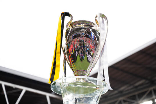 The Champions League trophy is displayed inside the stadium