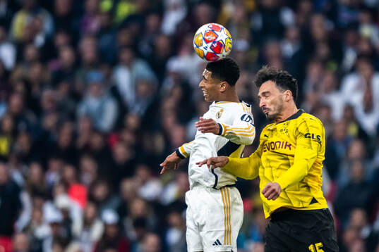 Jude Bellingham of Real Madrid and Mats Hummels of Dortmund