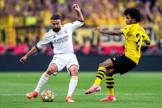 Dani Carvajal of Real Madrid and Karim Adeyemi of Dortmund
