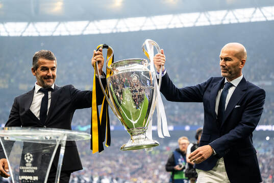 Former players Karl Heinz Riedle and Zinedine Zidane carry