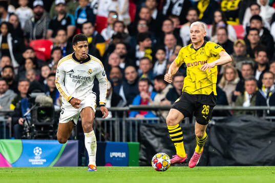 Julian Ryerson of Dortmund and Jude Bellingham of Real
