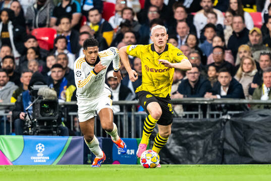 Julian Ryerson of Dortmund and Jude Bellingham of Real