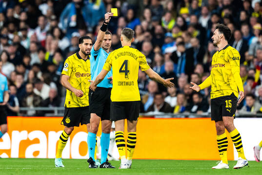Nico Schlotterbeck of Dortmund receives a yellow card