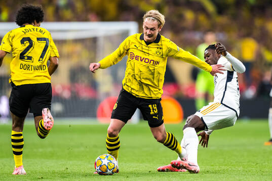 Julian Brandt of Dortmund and Eduardo Camavinga of Real