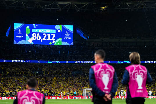 The big screen displays today's match attendance