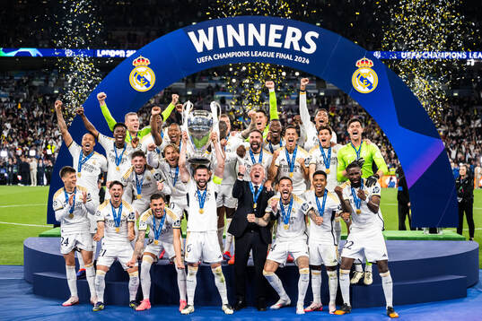 Players of Real Madrid celebrate with the trophy