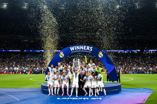Players of Real Madrid celebrate with the trophy