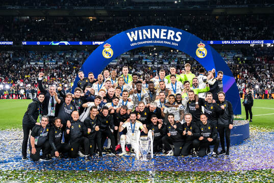 Players of Real Madrid celebrate with the trophy