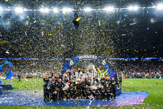 Players of Real Madrid celebrate with the trophy