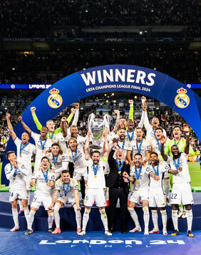 Nacho Fernandez of Real Madrid lifts the trophy
