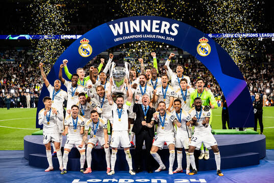 Nacho Fernandez of Real Madrid lifts the trophy
