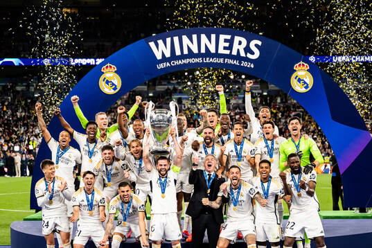Nacho Fernandez of Real Madrid lifts the trophy