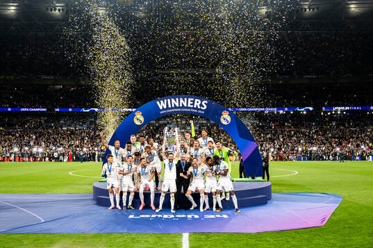 Nacho Fernandez of Real Madrid lifts the trophy