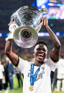 Vinicius Junior of Real Madrid celebrates with the trophy
