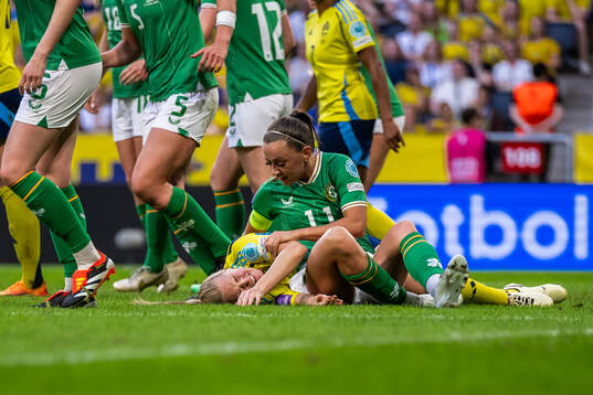 Magdalena Eriksson of Sweden in pain next to Katie McCabe