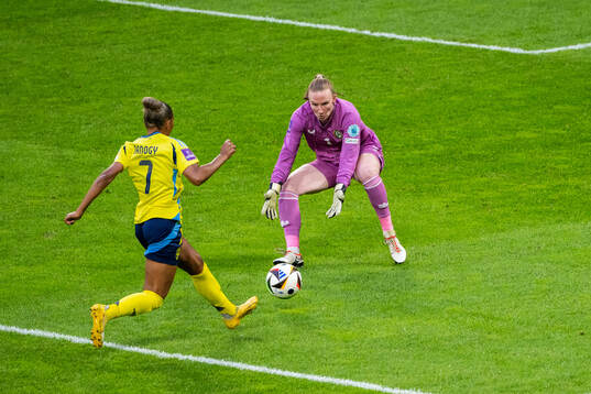 Madelen Janogy of Sweden and goalkeeper Courtney Brosnan of