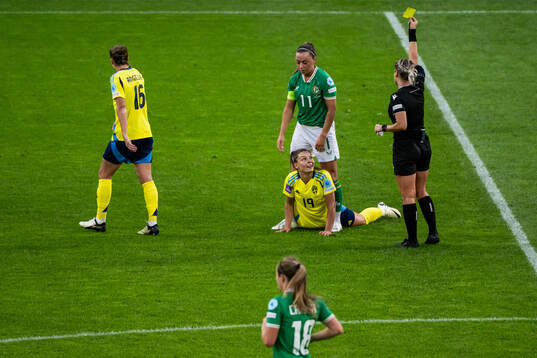 Johanna Rytting Kaneryd of Sweden watch as Katie McCabe of