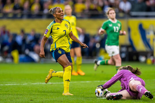 Madelen Janogy of Sweden and goalkeeper Courtney Brosnan of