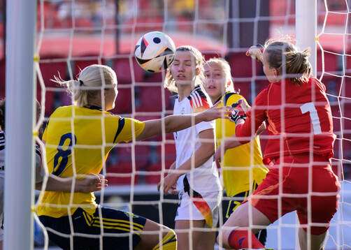 Wilma Leidhammar of Sweden and Goalkeeper Paula Hoppe of