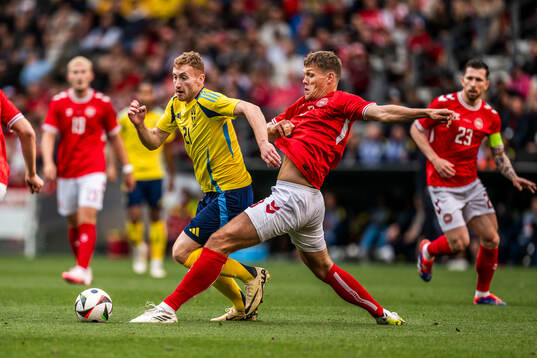 Dejan Kulusevski of Sweden and Jannik Vestergaard of Denmark