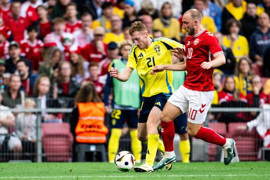 Dejan Kulusevski of Sweden and Christian Eriksen of Denmark