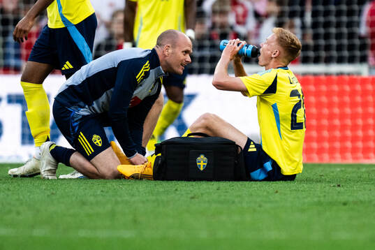 Hugo Larsson of Sweden receives medical attention