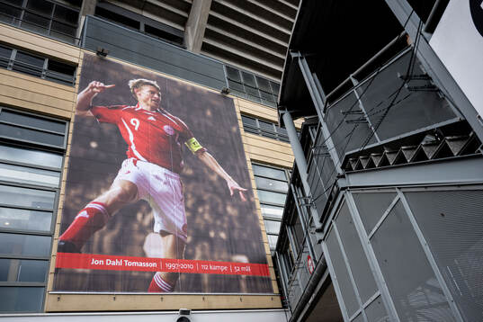 A poster of Jon Dahl Tomasson outside of Parken