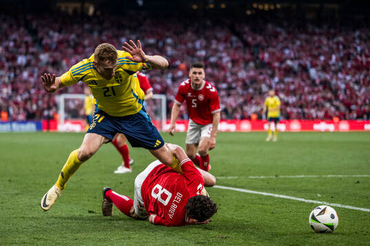 Dejan Kulusevski of Sweden and Thomas Delaney of Denmark