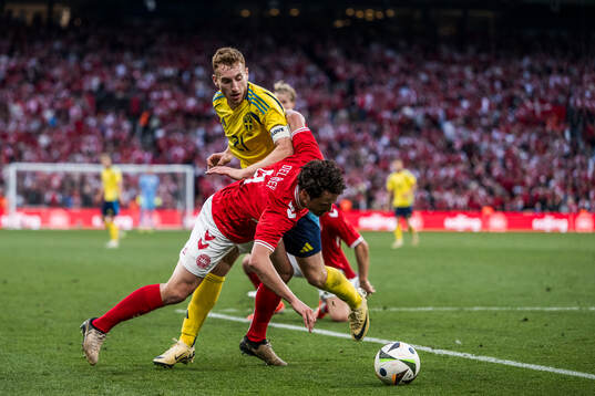 Dejan Kulusevski of Sweden and Thomas Delaney of Denmark