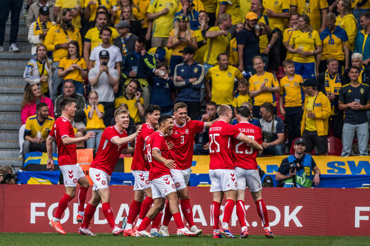Players of Denmark celebrate the 1-0 goal by Pierre-Emile