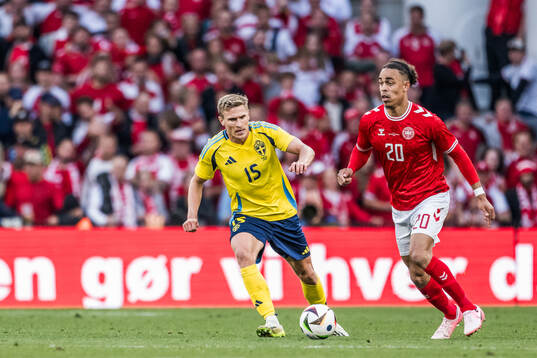 Carl Starfelt of Sweden and Yussuf Poulsen of Denmark