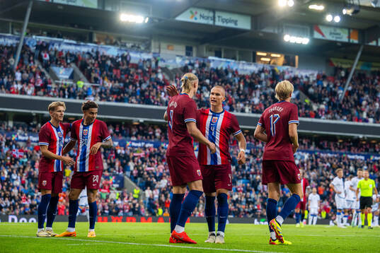 Erling Braut Haaland of Norway celebrates with teammate Leo