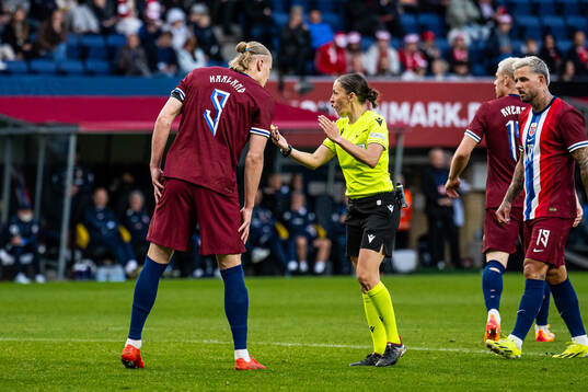Erling Braut Haaland of Norway and referee Stéphanie