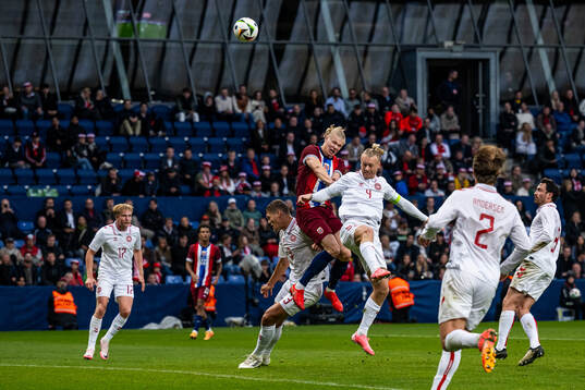 Erling Braut Haaland of Norway and Simon Kjær of Denmark